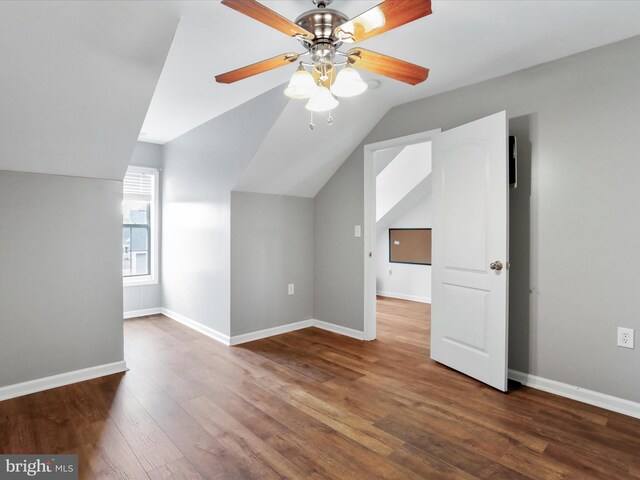 bonus room featuring vaulted ceiling, wood finished floors, ceiling fan, and baseboards