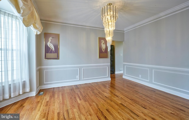 28 Autumnwood Ln, Mount Laurel, NJ 08054 - unfurnished dining area featuring a chandelier, healthy amount of natural light, wood finished floors, crown molding, and wainscoting