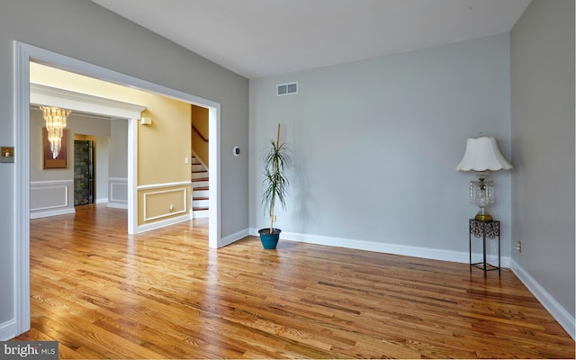 28 Autumnwood Ln, Mount Laurel, NJ 08054 - unfurnished room featuring wood finished floors, stairs, a chandelier, and baseboards