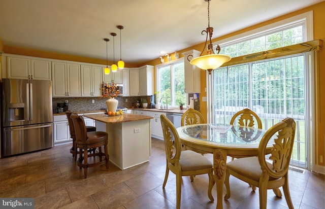 28 Autumnwood Ln, Mount Laurel, NJ 08054 - kitchen with appliances with stainless steel finishes, a center island, backsplash, a sink, and white cabinetry