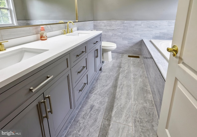 28 Autumnwood Ln, Mount Laurel, NJ 08054 - bathroom featuring toilet, double vanity, tile walls, and a wainscoted wall