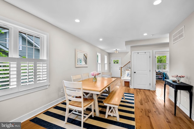 dining area featuring stairs, recessed lighting, light wood-style floors, and baseboards
