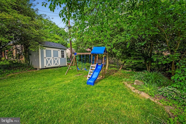 view of grassy yard with a storage shed, a playground, and an outdoor structure
