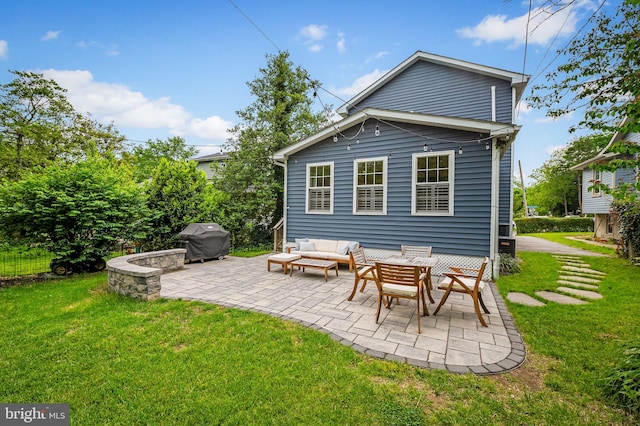 rear view of house featuring a patio, a lawn, and an outdoor living space