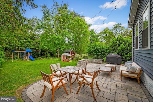 view of patio with a playground, area for grilling, a storage unit, an outdoor structure, and outdoor dining area