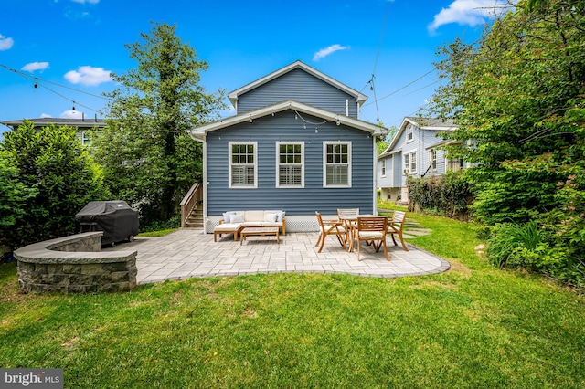 back of property with a patio, a lawn, an outdoor hangout area, and stairs