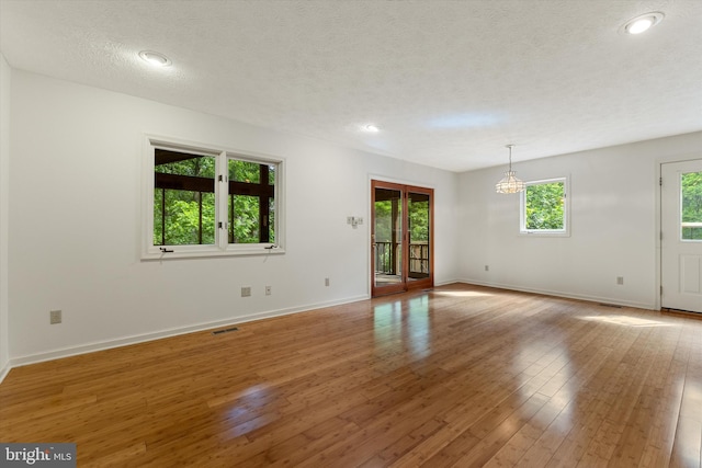 112 Old Forest Cir, Winchester, VA 22602 - empty room featuring baseboards, a textured ceiling, light wood-type flooring, a chandelier, and recessed lighting