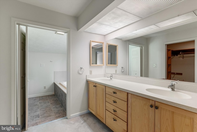 112 Old Forest Cir, Winchester, VA 22602 - bathroom with double vanity, a garden tub, baseboards, and a spacious closet