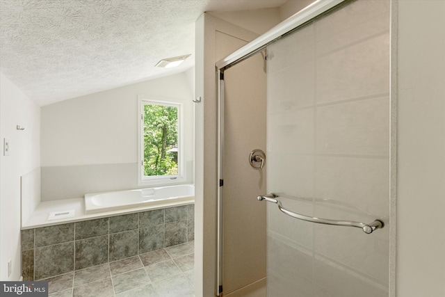 112 Old Forest Cir, Winchester, VA 22602 - bathroom featuring vaulted ceiling, a stall shower, a textured ceiling, and a bath