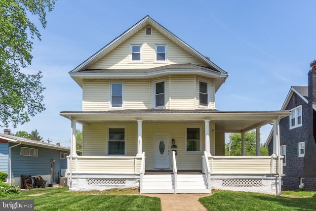 view of front facade with a front lawn and covered porch