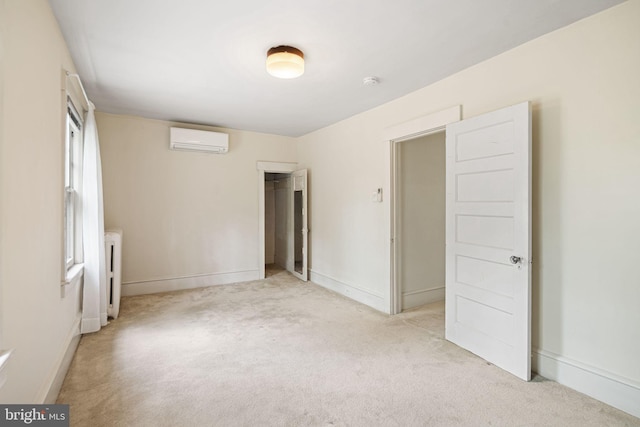 unfurnished bedroom featuring radiator, a wall mounted AC, light carpet, and baseboards