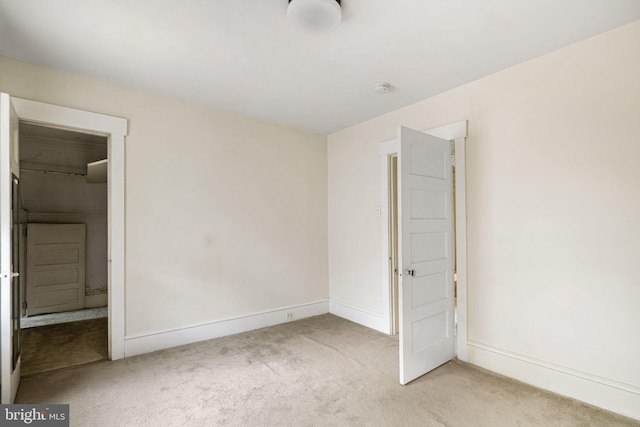 unfurnished bedroom featuring carpet and baseboards