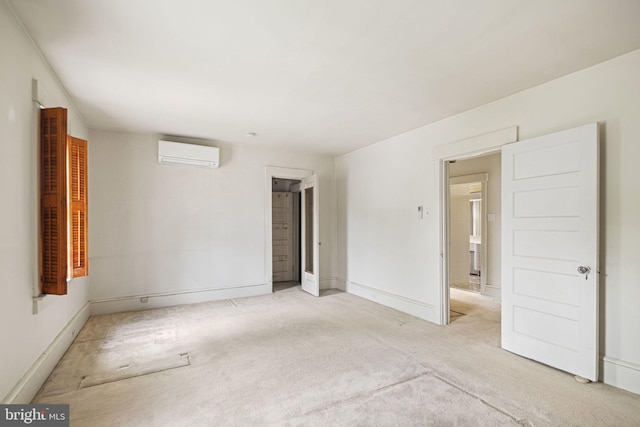 carpeted empty room featuring a wall mounted AC and baseboards