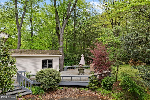 view of yard with a wooden deck and outdoor dining area