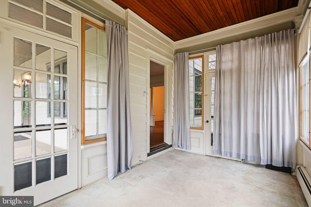 unfurnished sunroom featuring plenty of natural light and a baseboard radiator