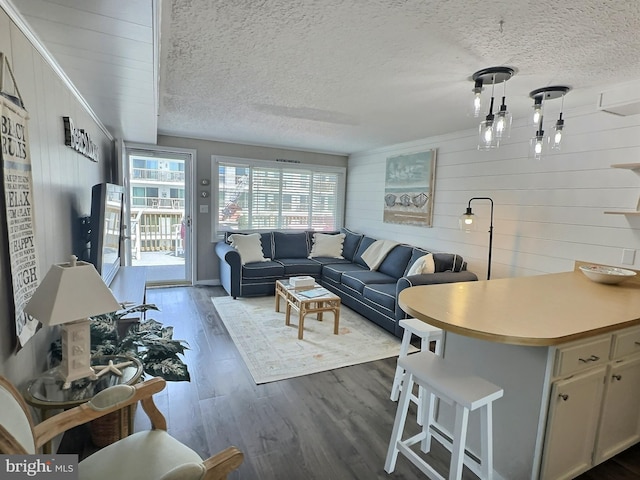 17 143rd St Unit 302, Ocean City, MD 21842 - living area with dark wood-style flooring, wooden walls, and a textured ceiling