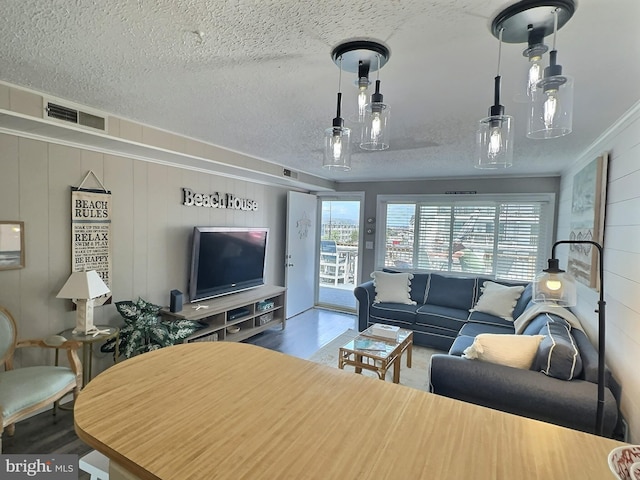 17 143rd St Unit 302, Ocean City, MD 21842 - living area featuring a textured ceiling, visible vents, and wood finished floors