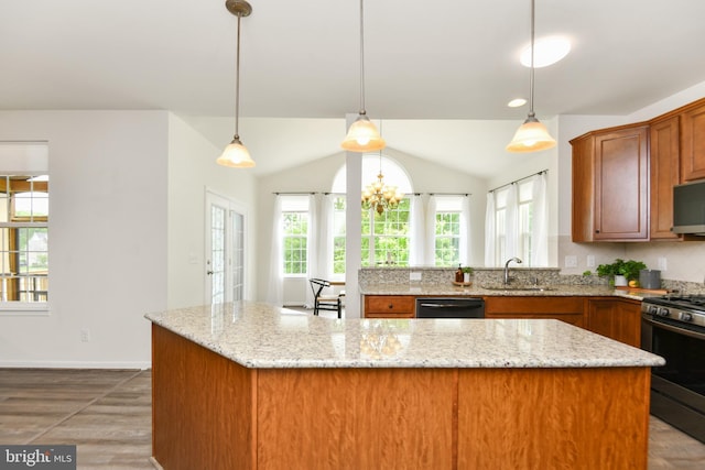kitchen with gas range oven, dishwasher, a sink, light stone counters, and brown cabinets