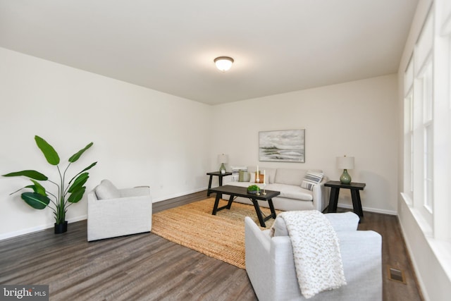 living room with dark wood finished floors and baseboards