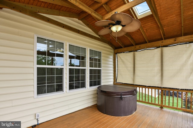 wooden terrace with a hot tub and a ceiling fan
