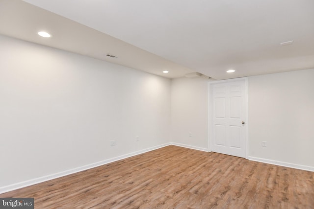 finished below grade area with recessed lighting, light wood finished floors, and baseboards
