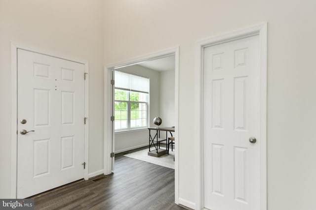 entrance foyer featuring dark wood-type flooring and baseboards