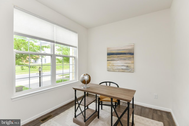 home office with baseboards and wood finished floors
