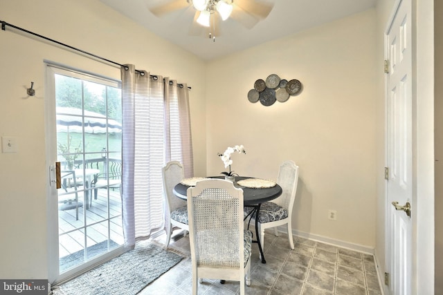 dining space featuring a ceiling fan and baseboards