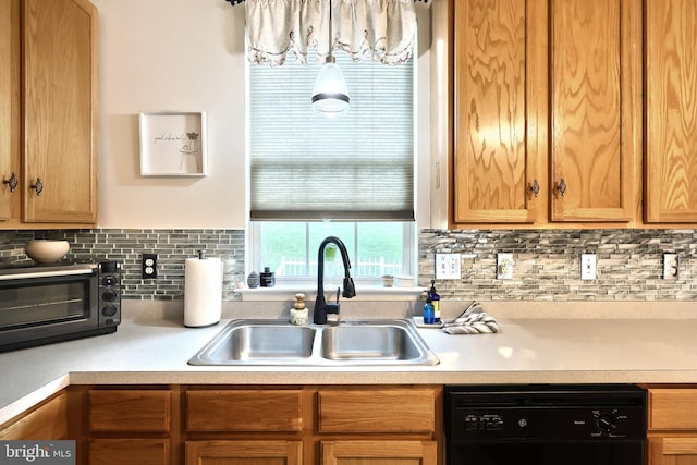 kitchen featuring a sink, dishwasher, tasteful backsplash, and light countertops