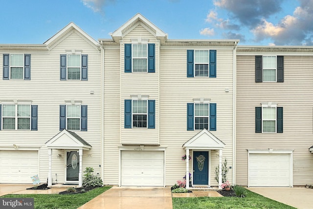 townhome / multi-family property featuring an attached garage and driveway