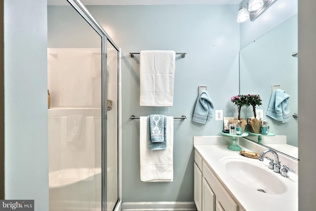 bathroom with a stall shower and vanity
