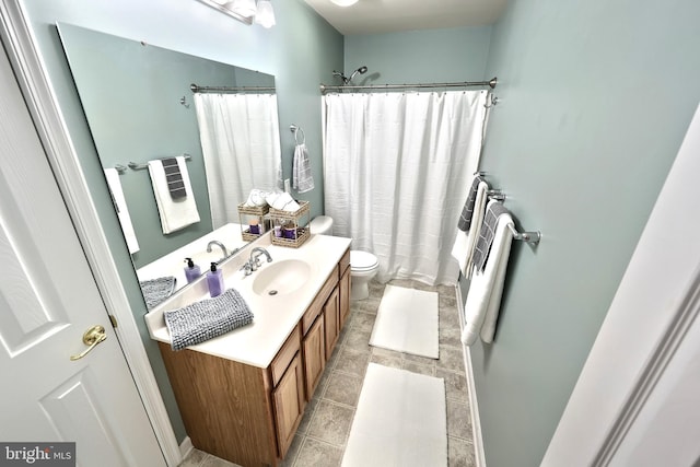 bathroom featuring toilet, vanity, a shower with curtain, and tile patterned floors