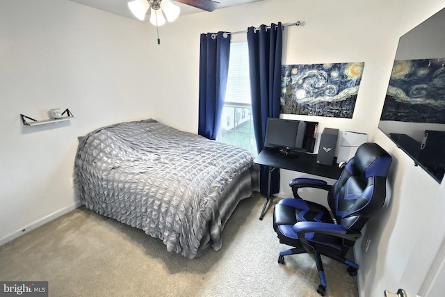 bedroom with carpet, baseboards, and an office area