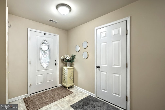 entrance foyer featuring baseboards and light tile patterned flooring