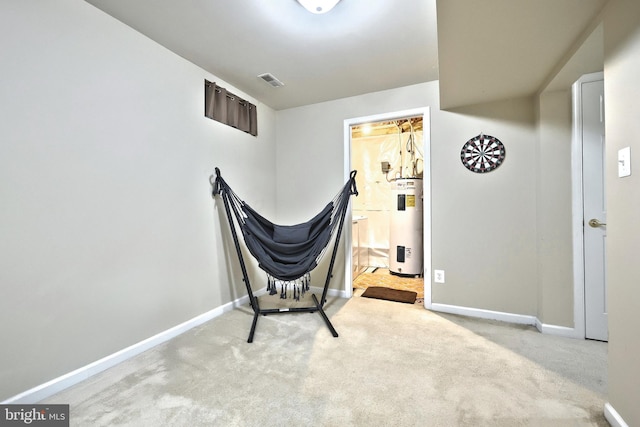 unfurnished room with water heater, light colored carpet, and baseboards