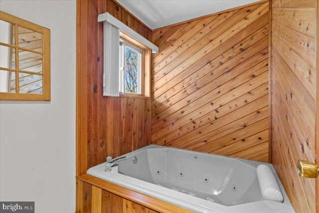 249 Hyland Dr, East Stroudsburg, PA 18301 - bathroom with a tub with jets and wood walls