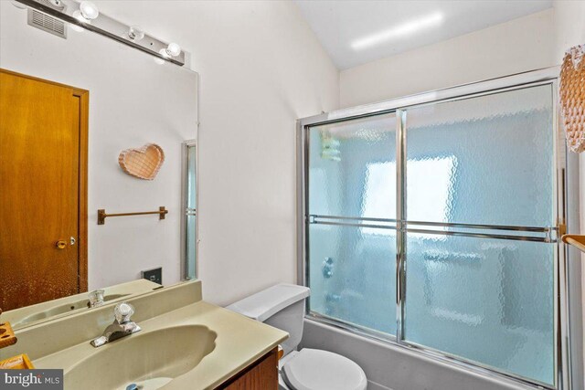 249 Hyland Dr, East Stroudsburg, PA 18301 - bathroom with vanity, toilet, visible vents, and combined bath / shower with glass door