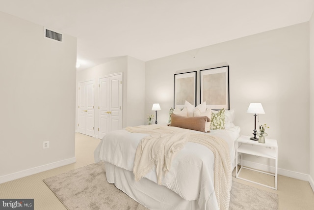 616 E St NW Unit 447, Washington, DC 20004 - carpeted bedroom featuring baseboards, multiple closets, and visible vents