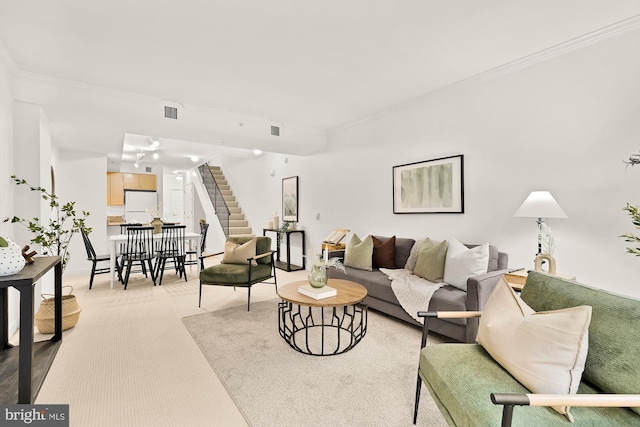 616 E St NW Unit 447, Washington, DC 20004 - living area featuring light colored carpet, crown molding, visible vents, and stairs