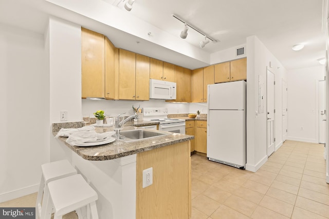 616 E St NW Unit 447, Washington, DC 20004 - kitchen with light tile patterned floors, white appliances, visible vents, a sink, and a peninsula