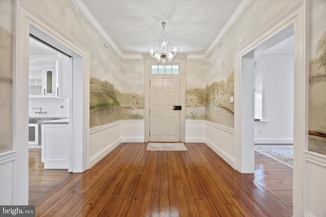 275 S Creek Rd, West Chester, PA 19382 - foyer featuring crown molding, wood-type flooring, a notable chandelier, and a wainscoted wall
