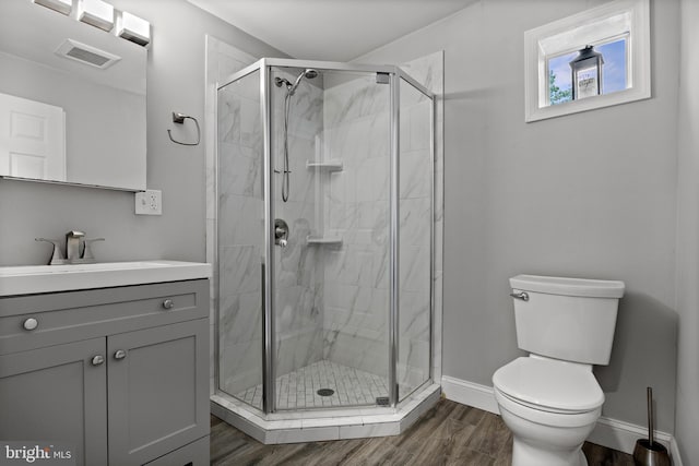 418 Vine St, Camden, NJ 08102 - full bathroom featuring toilet, a shower stall, vanity, and wood finished floors