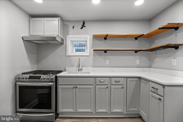 418 Vine St, Camden, NJ 08102 - kitchen featuring stainless steel gas range, under cabinet range hood, a sink, gray cabinetry, and open shelves