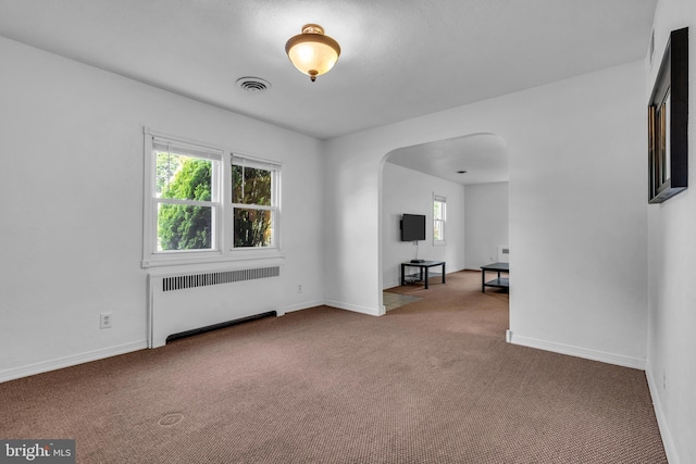 1545 Maple Ave, Haddon Heights, NJ 08035 - spare room with radiator heating unit, arched walkways, carpet flooring, and baseboards