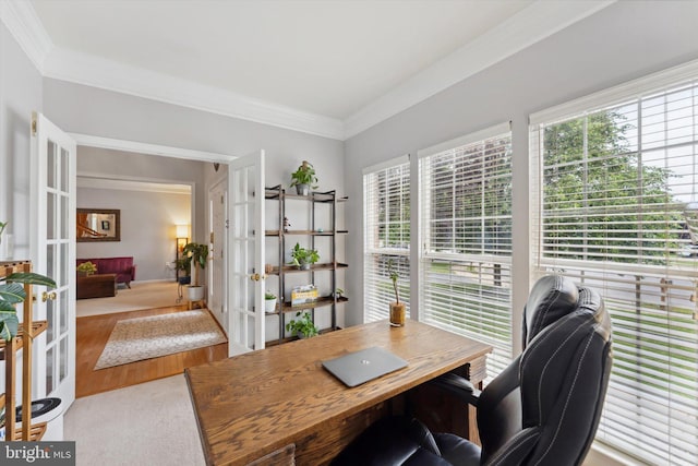office with french doors, healthy amount of natural light, crown molding, and wood finished floors