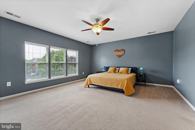 carpeted bedroom featuring baseboards and ceiling fan