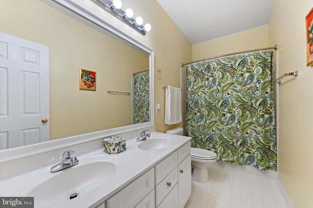 full bathroom featuring toilet, double vanity, and a shower with curtain