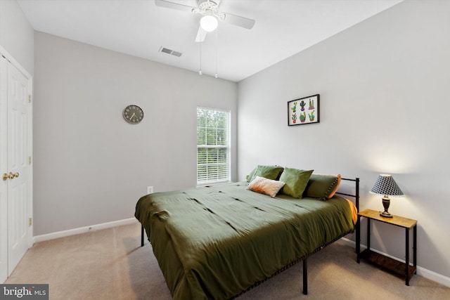 carpeted bedroom with baseboards and a ceiling fan