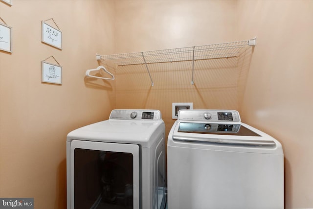 clothes washing area featuring washing machine and dryer