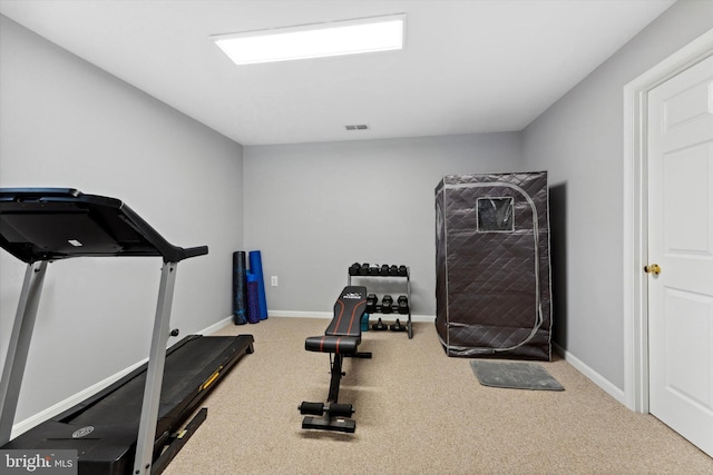 workout room with carpet flooring and baseboards